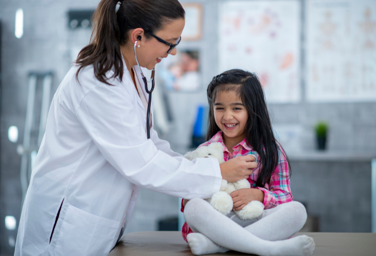 Pediatrician Checking a Young Girl's Heartbeat with a Stethoscope at a Pediatric Clinic